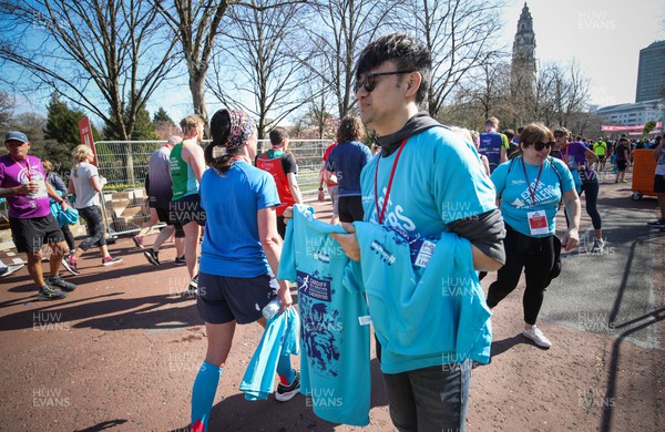 270322 - Cardiff University Cardiff Half Marathon - Finishers T Shirts are handed out at the end of the race