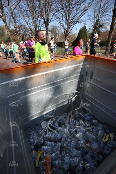 270322 - Cardiff University Cardiff Half Marathon - Empty water bottles are collected at the end of the race