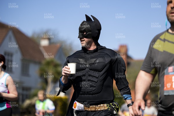 270322 - Cardiff University Cardiff Half Marathon - Runner in Batman costume at Roath Park