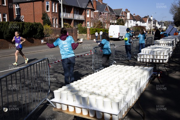 270322 - Cardiff University Cardiff Half Marathon - Volunteers hand out water at Roath Park