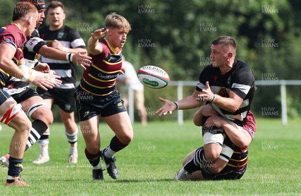 090923 - Cardiff Met v Bedwas RFC, Admiral Championship East - Dale Rogers of Bedwas offloads after he is tackled by Ben Murphy of Cardiff Met