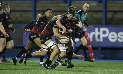 121218 - Cardiff Met v Cardiff University, BUCS Super League - Harvey Scott of Cardiff Met is tackled