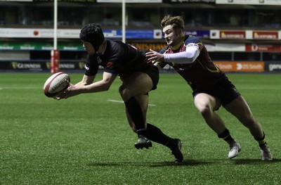 121218 - Cardiff Met v Cardiff University, BUCS Super League - Ioan Davies of Cardiff University tries to reach the ball as Tom Benjamin of Cardiff Met tackles