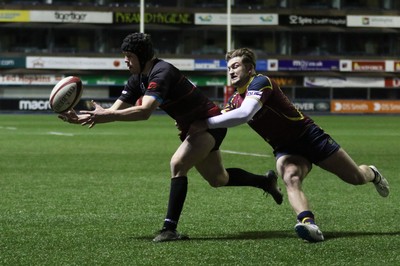 121218 - Cardiff Met v Cardiff University, BUCS Super League - Ioan Davies of Cardiff University tries to reach the ball as Tom Benjamin of Cardiff Met tackles