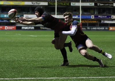 121218 - Cardiff Met v Cardiff University, BUCS Super League - Ioan Davies of Cardiff University tries to reach the ball as Tom Benjamin of Cardiff Met tackles