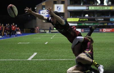 121218 - Cardiff Met v Cardiff University, BUCS Super League - Ioan Davies of Cardiff University tries to reach the ball as Tom Benjamin of Cardiff Met tackles