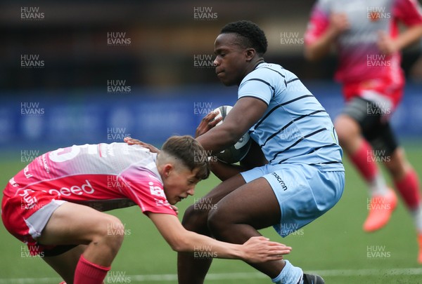 250821 - Cardiff Rugby U17s v Dragons Red U17s - Dan Nzamba of Cardiff Rugby is tackled by Tom Lewis of Dragons Red