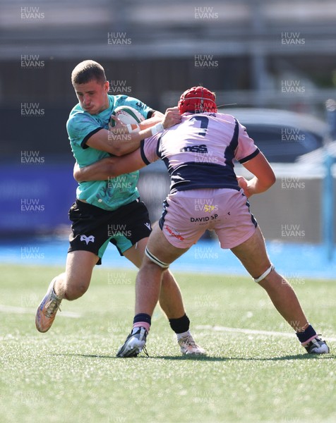 230826 - Cardiff Rugby U18 v Ospreys U18, WRU Regional Age Grade Championship - Dylan Quin of Ospreys takes on Alex Ballinger of Cardiff Rugby