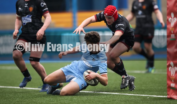 230122 - Cardiff Rugby U18 v RGC U18, Regional Age Grade Championship - Ethan Rudyj of Cardiff Rugby beats Charlie Probert of RGC to score try