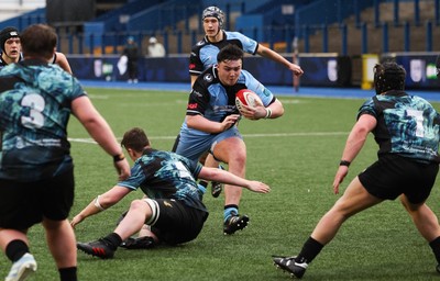 230225  Cardiff Rugby U18s v Ospreys U18s, WRU Regional Age Grade Championship Final - Ioan Dacey of Cardiff Rugby is tackled as he charges for the line