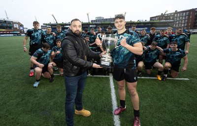 230225  Cardiff Rugby U18s v Ospreys U18s, WRU Regional Age Grade Championship Final - Jack Hoskins of Ospreys receives the trophy from John Alder, WRU Head of Player Development