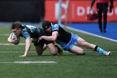 230225 - Cardiff Rugby U18s v Ospreys U18s - Regional Age-Grade Championship finals - Noah Mason of Ospreys U18s is challenged by Rhys Cummings of Cardiff Rugby