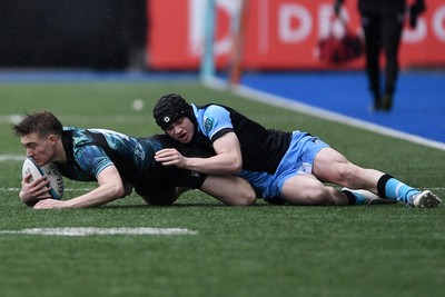 230225 - Cardiff Rugby U18s v Ospreys U18s - Regional Age-Grade Championship finals - Noah Mason of Ospreys U18s is challenged by Rhys Cummings of Cardiff Rugby