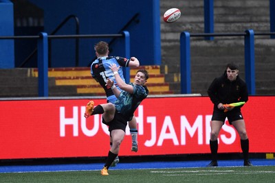 230225 - Cardiff Rugby U18s v Ospreys U18s - Regional Age-Grade Championship finals - Cian Evans of Ospreys U18s is challenged by Lloyd Lucas of Cardiff Rugby