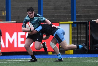 230225 - Cardiff Rugby U18s v Ospreys U18s - Regional Age-Grade Championship finals - Logan Heaven-Hearne of Ospreys U18s is challenged by Dylan Barrett of Cardiff Rugby