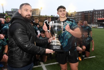 230225 - Cardiff Rugby U18s v Ospreys U18s - Regional Age-Grade Championship finals - Captain Jack Hoskins of Ospreys U18s is presented with the trophy