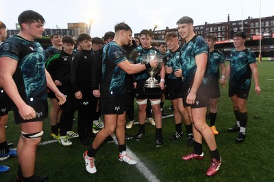 230225 - Cardiff Rugby U18s v Ospreys U18s - Regional Age-Grade Championship finals - Ospreys players celebrate with the trophy at full time