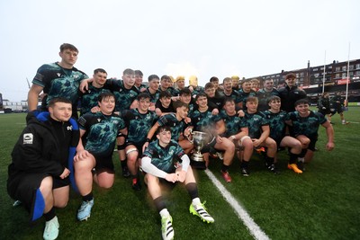 230225 - Cardiff Rugby U18s v Ospreys U18s - Regional Age-Grade Championship finals - Ospreys players celebrate with the trophy at full time