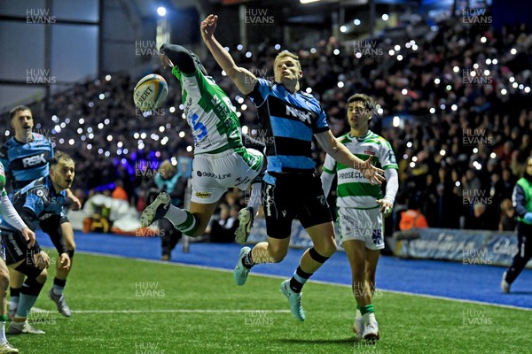 240126 - Cardiff Rugby v Benetton Rugby - United Rugby Championship - Aled Davies of Cardiff Rugby is challenged by Rhyno Smith of Benetton whilst Cardiff fans shine their phone lights in protest in the 11th minute due to the potential changes to Welsh Rugby 
