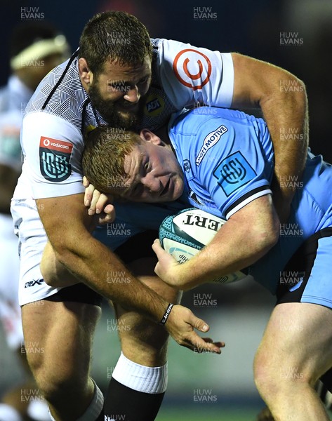 161021 - Cardiff Rugby v Cell C Sharks - United Rugby Championship - Rhys Carre of Cardiff is tackled by Thomas du Toit of Sharks