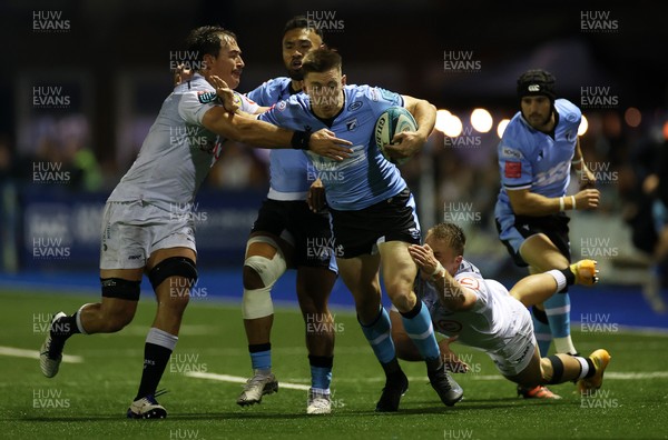 161021 - Cardiff Rugby v Cell C Sharks - United Rugby Championship - Josh Adams of Cardiff is tackled by Marnus Potgieter and Henco Venter of Sharks