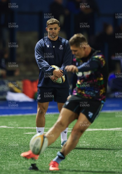 111025 - Cardiff Rugby v Connacht Rugby, United Rugby Championship - Leigh Halfpenny looks on as Callum Sheedy of Cardiff Rugby practices his kicking