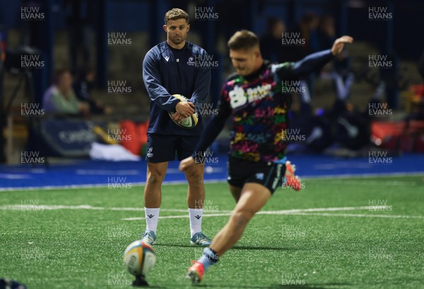 111025 - Cardiff Rugby v Connacht Rugby, United Rugby Championship - Leigh Halfpenny looks on as Callum Sheedy of Cardiff Rugby practices his kicking