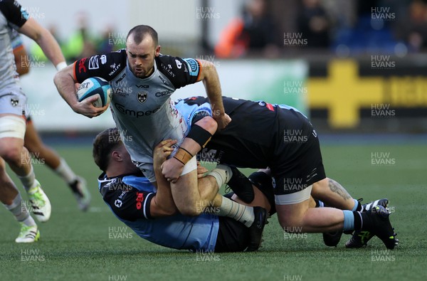 261223 - Cardiff Rugby v Dragons RFC - United Rugby Championship - Cai Evans of Dragons is tackled by Mason Grady of Cardiff 