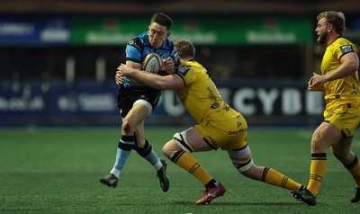 261225 - Cardiff Rugby v Dragons RFC, United Rugby Championship - Josh Adams of Cardiff Rugby takes on Matthew Screech of Dragons RFC’