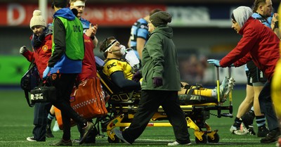 261225 - Cardiff Rugby v Dragons RFC, United Rugby Championship - Robert Hunt of Dragons RFC is treated for an injury before being stretchered from the pitch