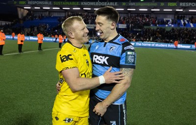 261225 - Cardiff Rugby v Dragons RFC, United Rugby Championship - Tinus de Beer of Dragons RFC and Josh Adams of Cardiff Rugby at the end of the match