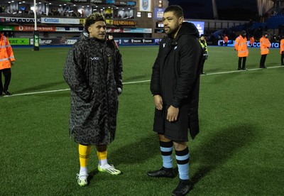 261225 - Cardiff Rugby v Dragons RFC, United Rugby Championship - Fine Inisi of Dragons RFC and Taulupe Faletau of Cardiff Rugby at the end of the match