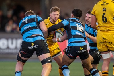 261225 - Cardiff Rugby v Dragons RFC - United Rugby Championship - Angus O’Brien of Dragons is tackled by Josh McNally of Cardiff Rugby and Ben Thomas of Cardiff Rugby