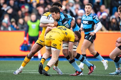261225 - Cardiff Rugby v Dragons RFC - United Rugby Championship - Rory Thornton of Cardiff Rugby is tackled by Rio Dyer of Dragons and Aneurin Owen of Dragons