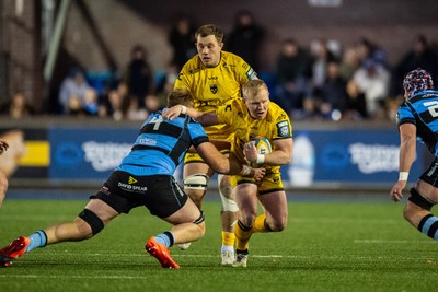 261225 - Cardiff Rugby v Dragons RFC - United Rugby Championship - Tinus de Beer  of Dragons is tackled by Josh McNally of Cardiff Rugby