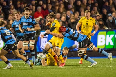 261225 - Cardiff Rugby v Dragons RFC - United Rugby Championship - Rhodri Williams of Dragons is tackled by Liam Botham of Cardiff Rugby