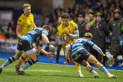 261225 - Cardiff Rugby v Dragons RFC - United Rugby Championship - Rio Dyer of Dragons is tackled by Josh Adams of Cardiff Rugby and Cam Winnett of Cardiff Rugby