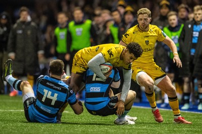 261225 - Cardiff Rugby v Dragons RFC - United Rugby Championship - Rio Dyer of Dragons is tackled by Josh Adams of Cardiff Rugby and Cam Winnett of Cardiff Rugby