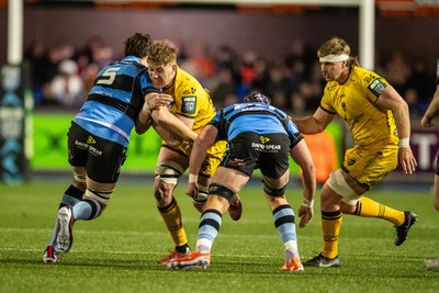 261225 - Cardiff Rugby v Dragons RFC - United Rugby Championship - Matthew Screech of Dragons is tackled by Rory Thornton of Cardiff Rugby and Alun Lawrence of Cardiff Rugby