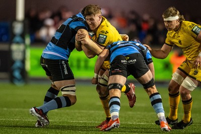 261225 - Cardiff Rugby v Dragons RFC - United Rugby Championship - Matthew Screech of Dragons is tackled by Rory Thornton of Cardiff Rugby and Alun Lawrence of Cardiff Rugby