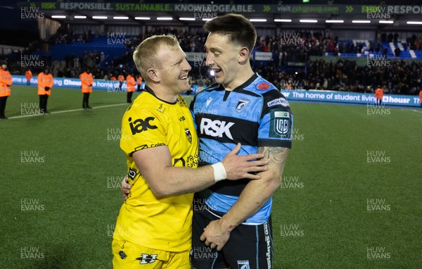 261225 - Cardiff Rugby v Dragons RFC, United Rugby Championship - Tinus de Beer of Dragons RFC and Josh Adams of Cardiff Rugby at the end of the match