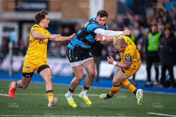 261225 - Cardiff Rugby v Dragons RFC - United Rugby Championship - Mason Grady of Cardiff Rugby fends off Tinus de Beer  of Dragons