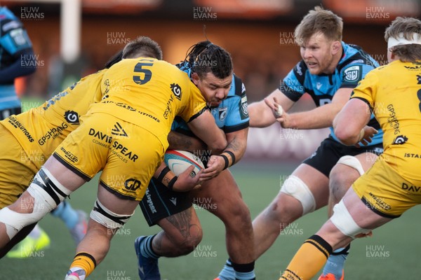 261225 - Cardiff Rugby v Dragons RFC - United Rugby Championship - Javan Sebastian of Cardiff Rugby is tackled by Ben Carter of Dragons