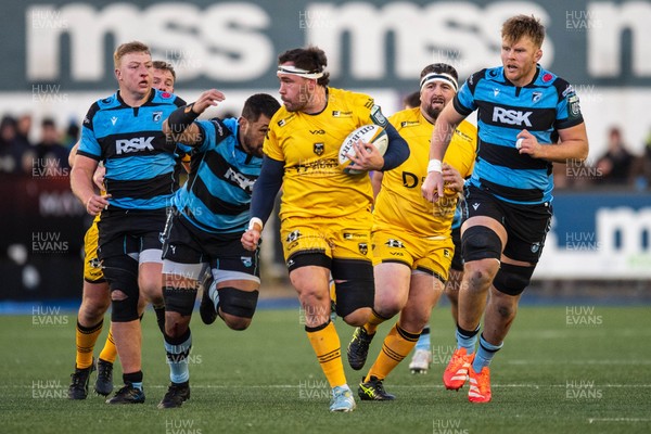 261225 - Cardiff Rugby v Dragons RFC - United Rugby Championship - Robert Hunt of Dragons is tackled by Taulupe Faletau of Cardiff Rugby