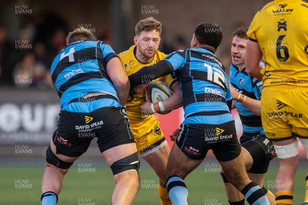 261225 - Cardiff Rugby v Dragons RFC - United Rugby Championship - Angus O’Brien of Dragons is tackled by Josh McNally of Cardiff Rugby and Ben Thomas of Cardiff Rugby