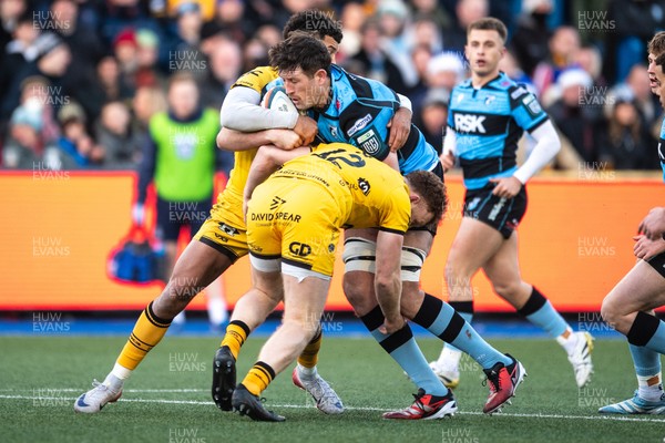 261225 - Cardiff Rugby v Dragons RFC - United Rugby Championship - Rory Thornton of Cardiff Rugby is tackled by Rio Dyer of Dragons and Aneurin Owen of Dragons