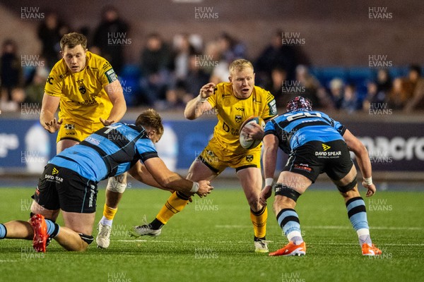 261225 - Cardiff Rugby v Dragons RFC - United Rugby Championship - Tinus de Beer  of Dragons is tackled by Josh McNally of Cardiff Rugby and Alun Lawrence of Cardiff Rugby