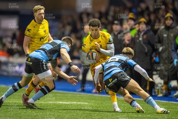 261225 - Cardiff Rugby v Dragons RFC - United Rugby Championship - Rio Dyer of Dragons is tackled by Josh Adams of Cardiff Rugby and Cam Winnett of Cardiff Rugby