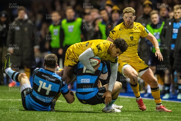 261225 - Cardiff Rugby v Dragons RFC - United Rugby Championship - Rio Dyer of Dragons is tackled by Josh Adams of Cardiff Rugby and Cam Winnett of Cardiff Rugby