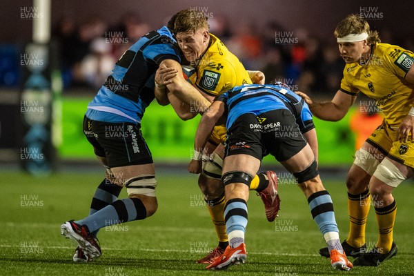 261225 - Cardiff Rugby v Dragons RFC - United Rugby Championship - Matthew Screech of Dragons is tackled by Rory Thornton of Cardiff Rugby and Alun Lawrence of Cardiff Rugby